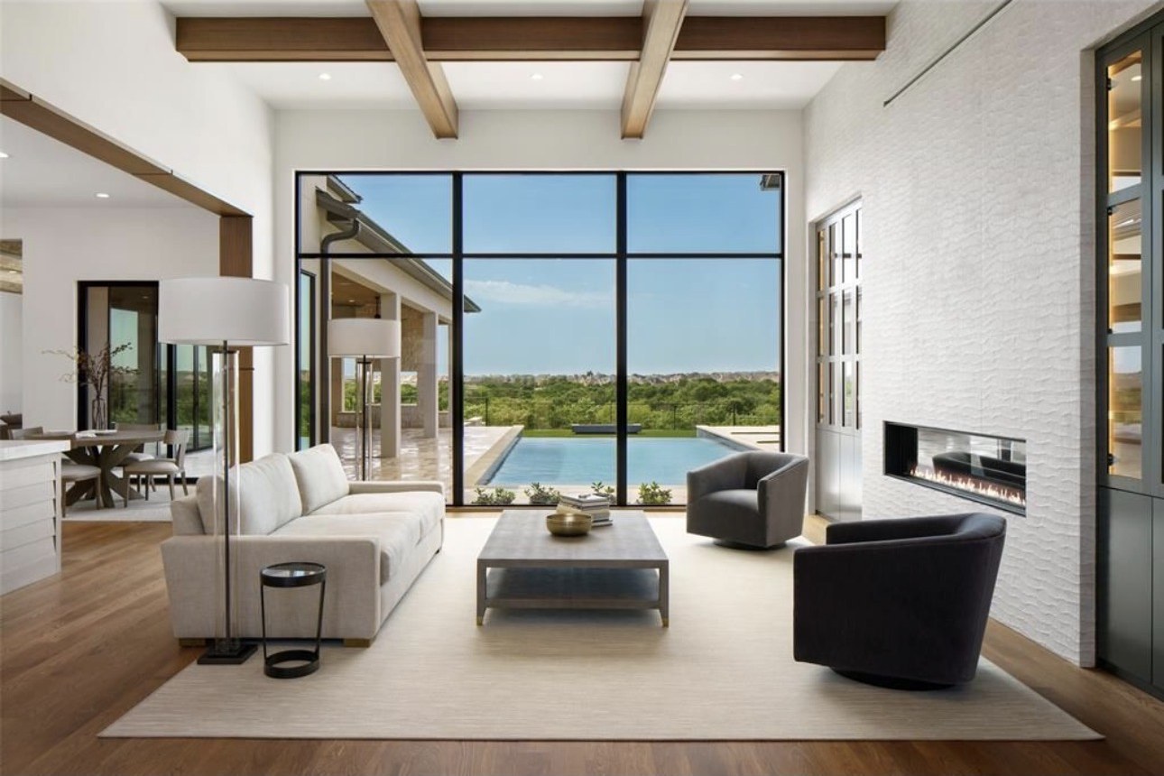 Great room with beamed ceiling and walls of glass